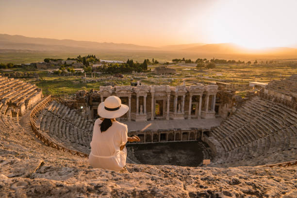 Hierapolis ancient city Pamukkale Turkey, young woman with hat watching sunset by the ruins Unesco Turkey, Hierapolis ancient city Pamukkale Turkey, young woman with hat watching sunset by the ruins Unesco denizli stock pictures, royalty-free photos & images