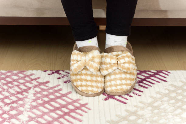istock Child's feet on carpet 1214541843