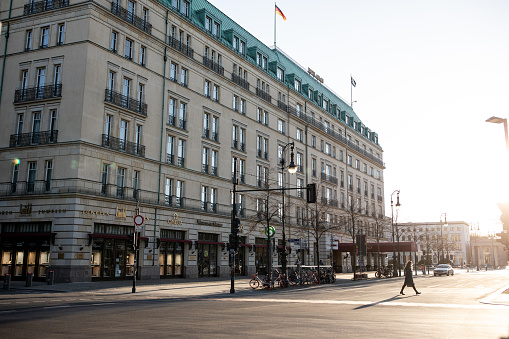 Berlin, Germany - March 23, 2020: The area around Hotel Adlon at Berlin's Brandenburg Gate is empty due to the restrictions implemented by the German goverment to mitigate the effects of COVID-19