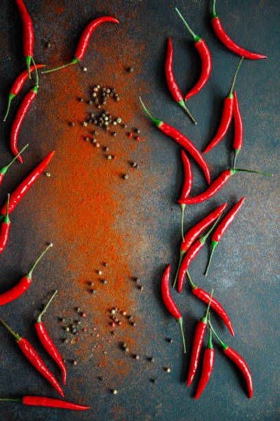 istock A lot of chili peppers on a kitchen table. Top view. 1214542870