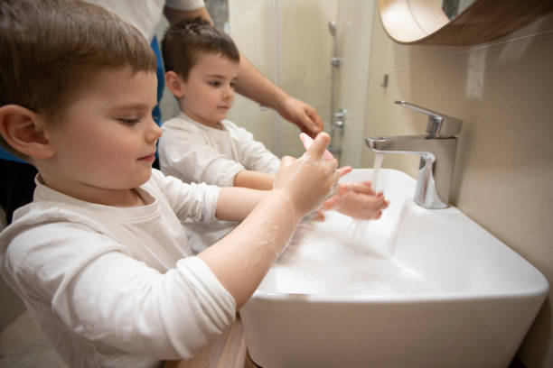 istock Children washing their hands with father 1214543479