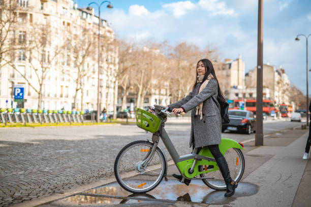 istock Asian woman using e-bicycle in the city 1214543622
