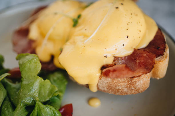 istock benedict egg with bacon and salad on the white plate 1214544982