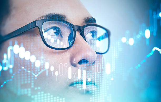 istock Asian investor in glasses, digital graph 1214545024