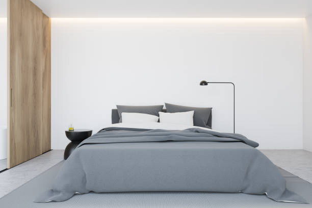 istock White master bedroom interior with wooden door 1214546688