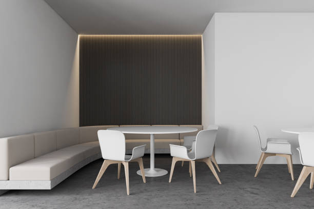 istock Modern white and gray cafe with round tables 1214546736