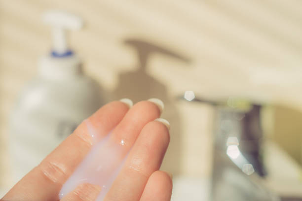 istock Female fingers with white wet soap drop. 1214550669