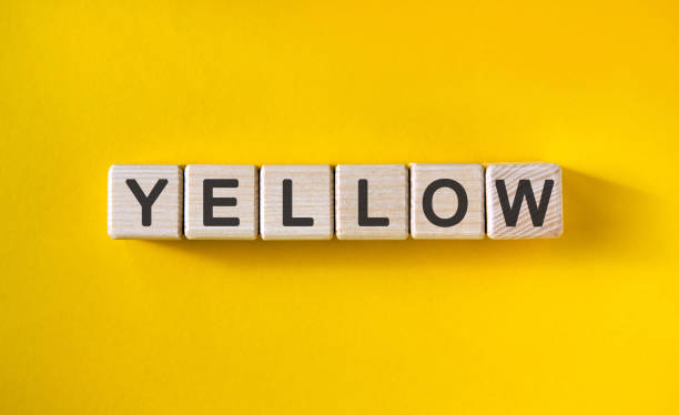 istock YELLOW text on cubes on a yellow homogeneous background 1214551915