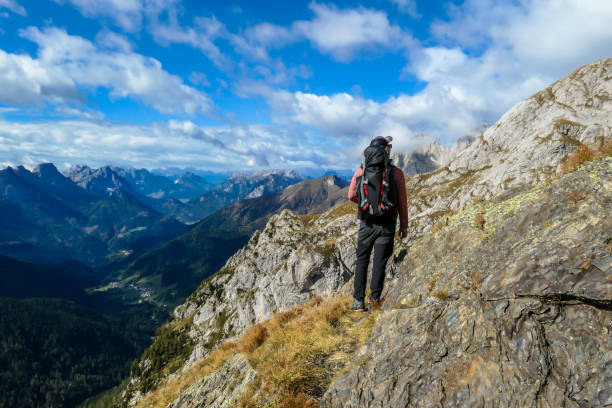 istock High Wait - A man walking to the Alpine peak 1214553413
