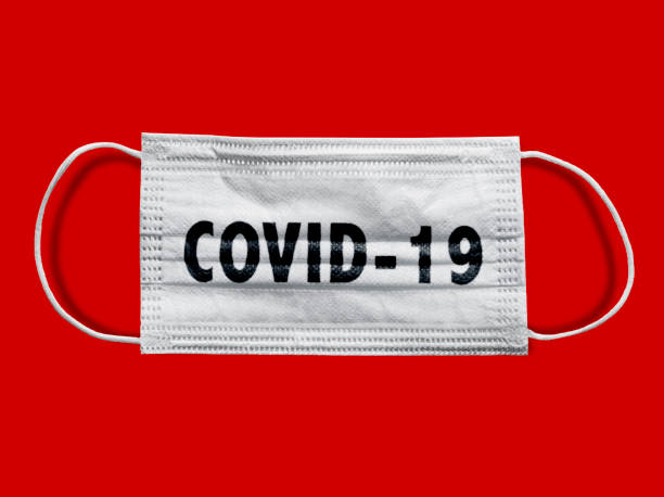 istock Protective face mask on a red background, COVID-19 (including Clipping Path) 1214554662