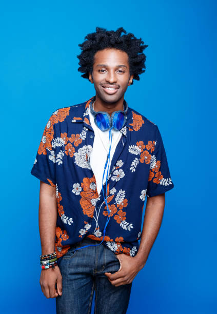 istock Confident young man in hawaiian shirt on blue background 1214556131