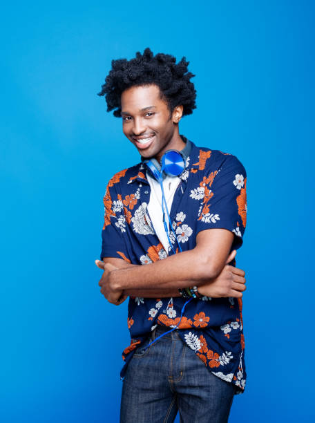 istock Confident young man in hawaiian shirt on blue background 1214557140