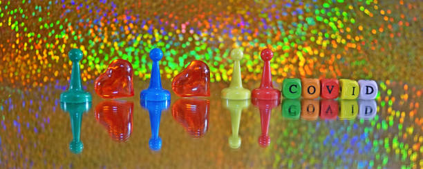 istock Spaced pawns showing to keep distance not to spread COVID-19 virus rainbow background 1214558268