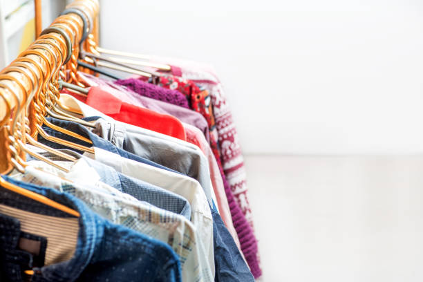 istock Lot of different clothes on hangers. Copy space 1214558636