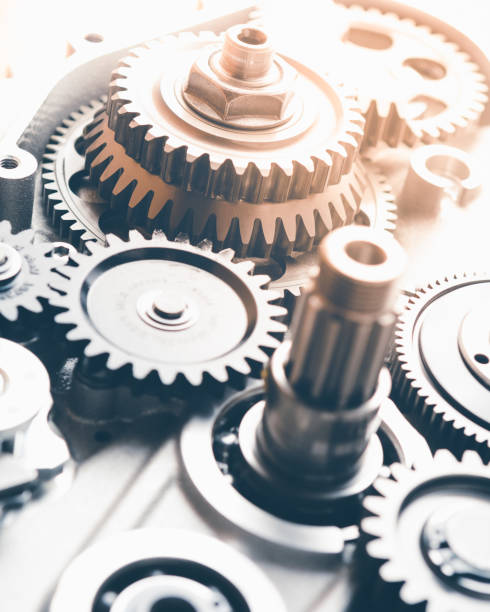 istock gears industrial background with warm shiny light 1214558651