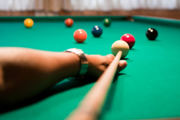 Group of multi-colored pool balls on a table in blurred motion.