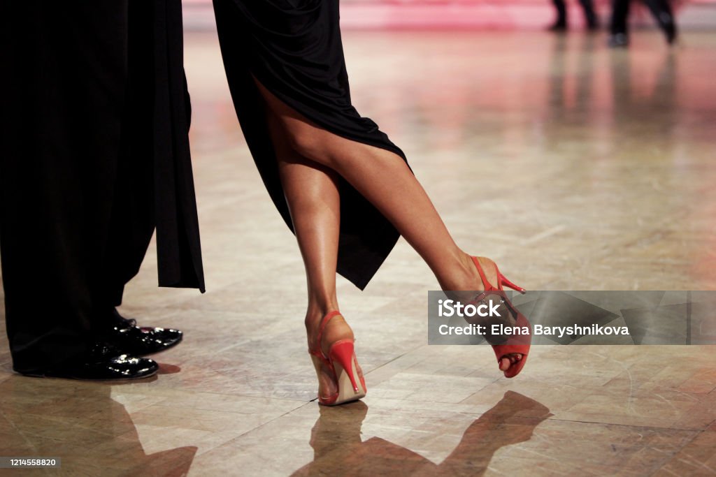 Argentinian tango Couple dancing tango indoors. Beautiful line in feet. Red shoes. Tango - Dance Stock Photo