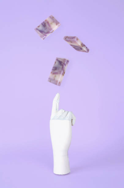 istock Gloved hand playing with levitating soap bars. Cleaning Hands Concept. 1214558854