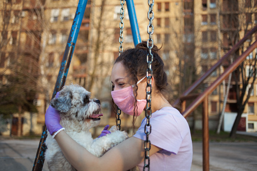 Girl playing with her dog on the playground
