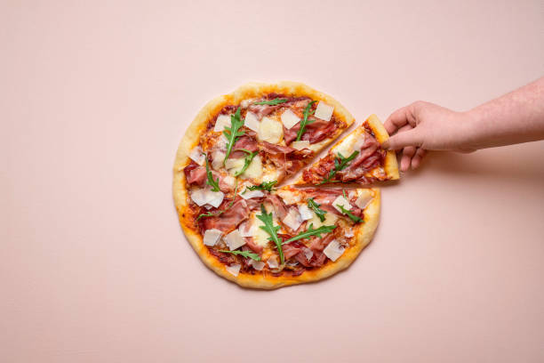istock Pizza ham and cheese on pink background. Taking pizza slice 1214559741