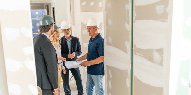 istock Architects and interior designers talking with the owner in a house 1214560513