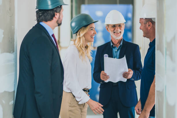 istock Architects and interior designers talking with the owner in a house 1214560524
