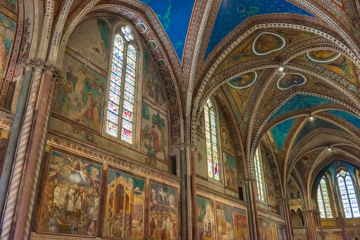 Assisi, Italy - July 24, 2016: Basilica of San Francesco, visited by pilgrims and tourists from all over the world, preserves the remains of the saint,frescoed ceilings and walls inside the Basilica