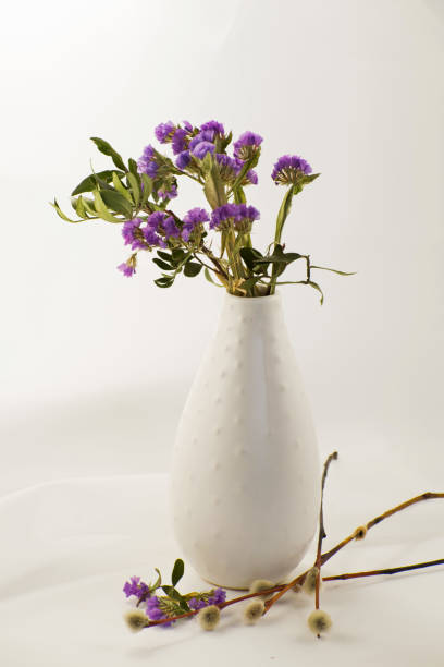 istock Spring lilac flowers with willow branches in a vase. 1214561787