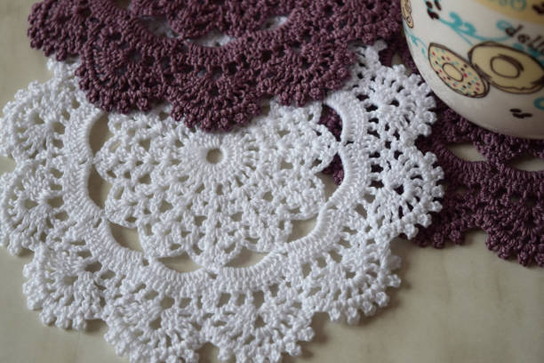 White and purple hand hooked coaster. Set of supports for hot dishes