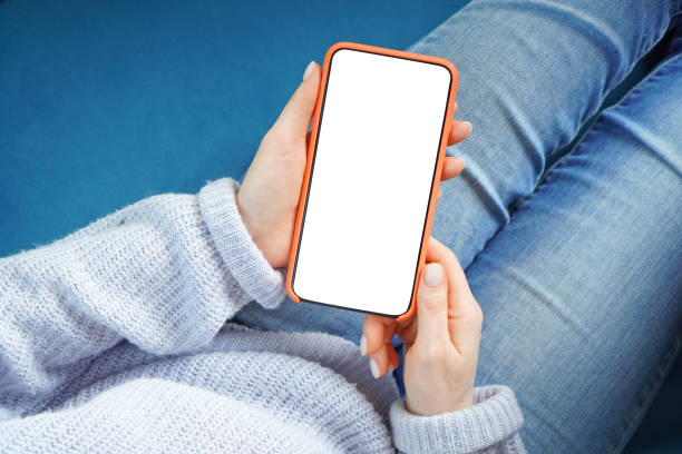 istock Smartphone with empty screen in a woman hands. White display for the copy space. View above. 1214564809