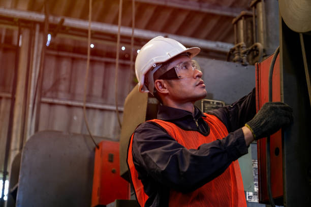 istock Asian worker or technician works with machine in factory 1214565120