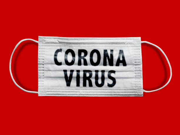 istock Protective face mask on a red background, Coronavirus (including Clipping Path) 1214565512