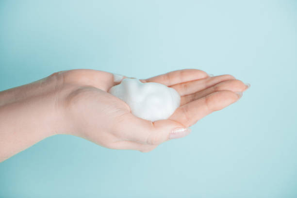 istock Soap foam in the hand. Coronavirus prevention, antiseptic on a blue background. 1214566759