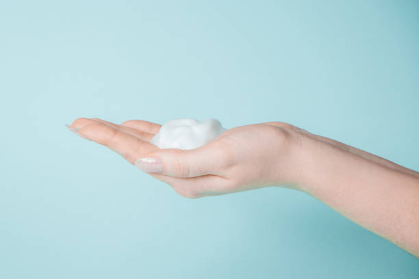 istock Soap foam in the hand. Coronavirus prevention, antiseptic on a blue background. 1214566902
