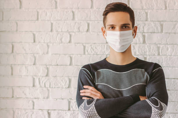 istock Professional fitness trainer in protective face mask 1214570136