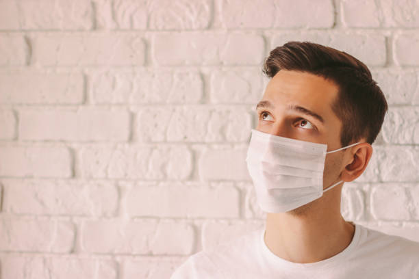 istock Thoughtful doctor in face mask looking on copy space 1214570751