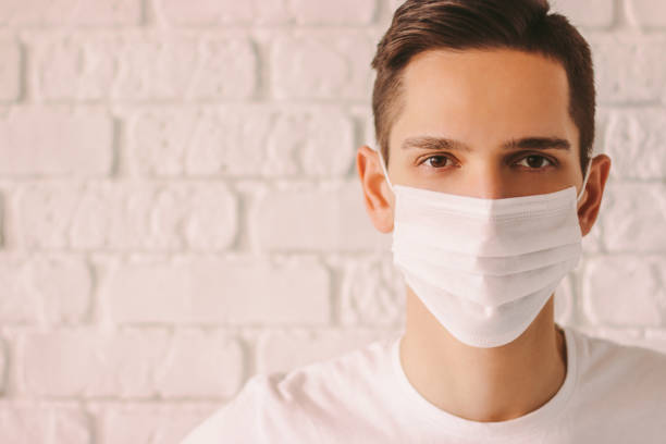 istock Exhausted young doctor in white medical mask 1214570800