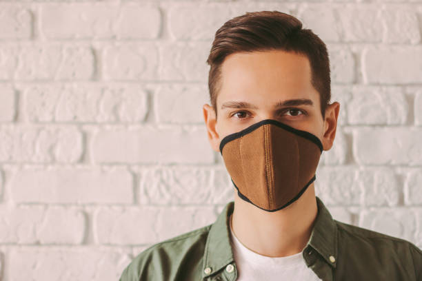 istock Stylish hipster man wearing protective face mask 1214570819