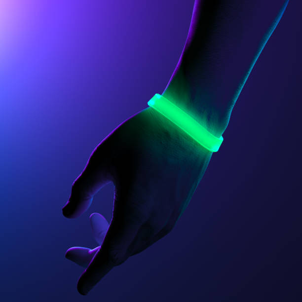 istock Neon Illuminated Green Rubber Bracelets on Hand On Dark Background. Elastic Wrist Bands With Empty Space. 3d Rendering 1214570885