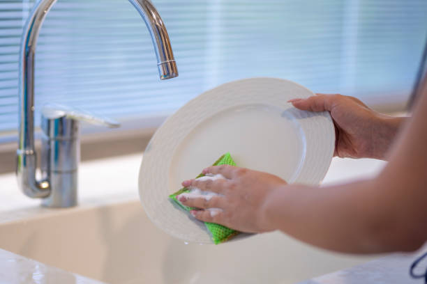 istock woman washing plates in the kitchen 1214571178