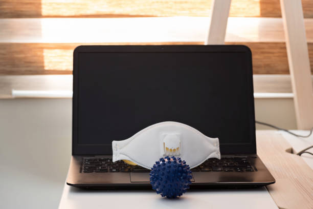 istock Black notebook with protecting mask and glasses and antiseptic. Microscope corona virus close up. Coronavirus concept. Work from home concept 1214572135
