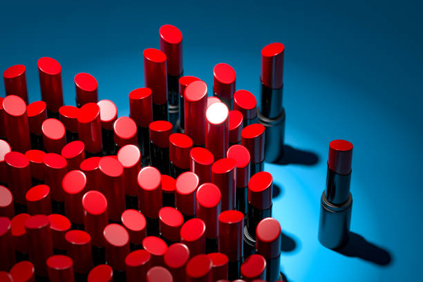 istock Red Glossy Lipsticks On Blue Background Illuminated By Spotlight. Cosmetics For Modern Luxury Make Up. 3d Rendering. 1214572136