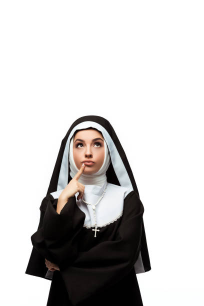 istock thoughtful nun in black clothing looking up, isolated on white 1214572421