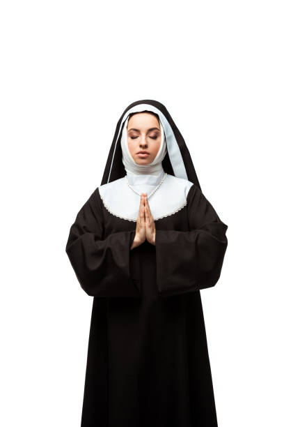 istock nun praying with closed eyes and hands together isolated on white 1214572429
