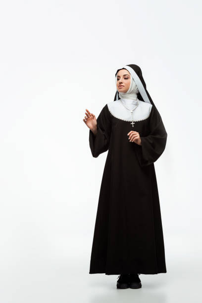 istock beautiful young happy nun standing on white 1214572436