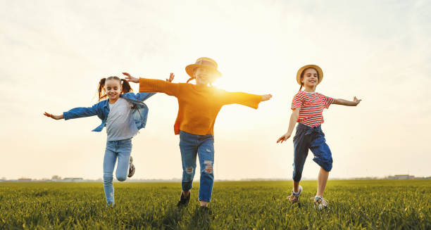 istock Happy children running in field 1214574361