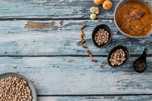Organic beans soup and spices on blue wooden background