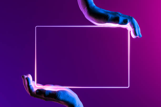 istock Human Hands Holding Neon Frame. Hands Illuminated by Pink, Violet and Blue Neon Lights. 3d rendering 1214574722