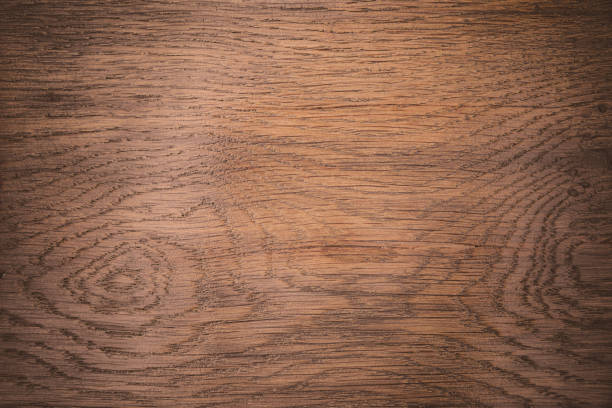 Horizontal photograhy of a dark brown wood texture, with wood grain and knot abstract backgrounds with blank copy space ready for design, taken in close-up full frame. Low contrast image, for inspiration, simplicity, tranquility and sparse concepts.