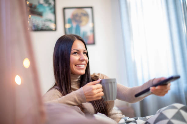 istock Young woman is watching television. 1214577812